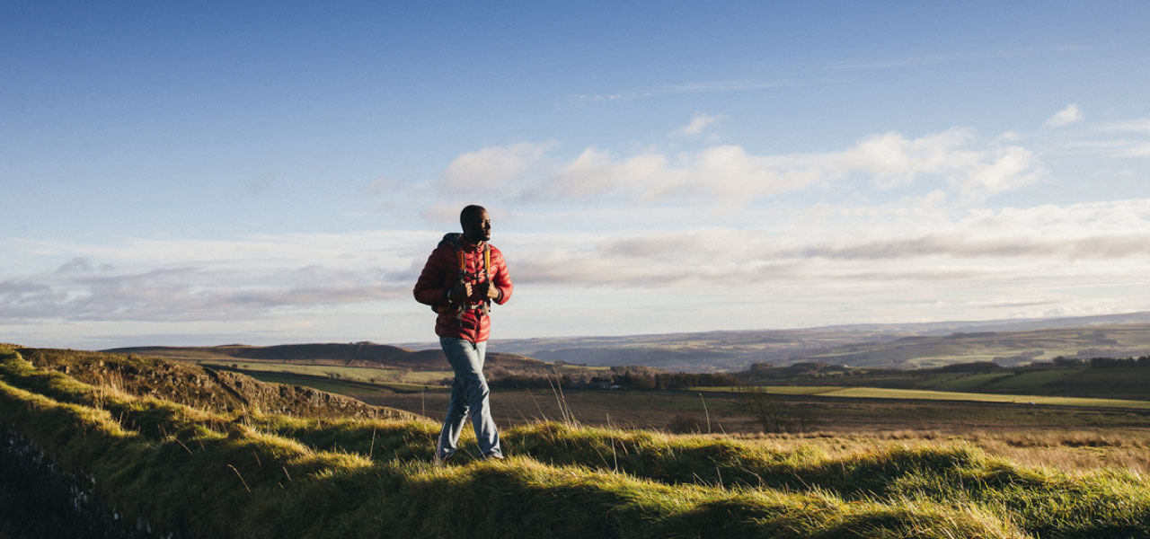 A man walking alone on a sunny day